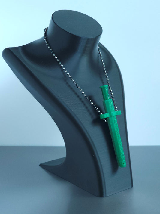 Sniff & Slide spring-loaded dispenser pendant in emerald Green with silver ball chain, displayed on black mannequin bust, over a white and grey background