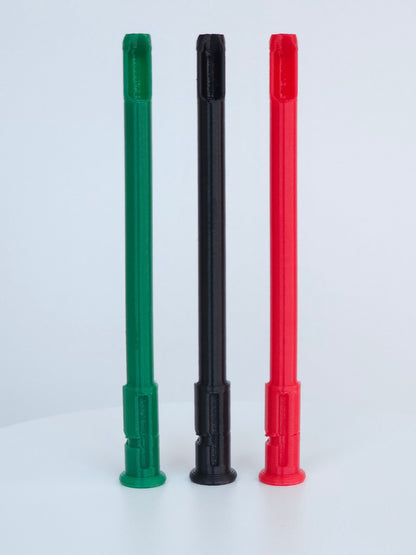 Three plastic straw and scoop inserts, red, black and green, arranged vertically on a round white display pedestal.