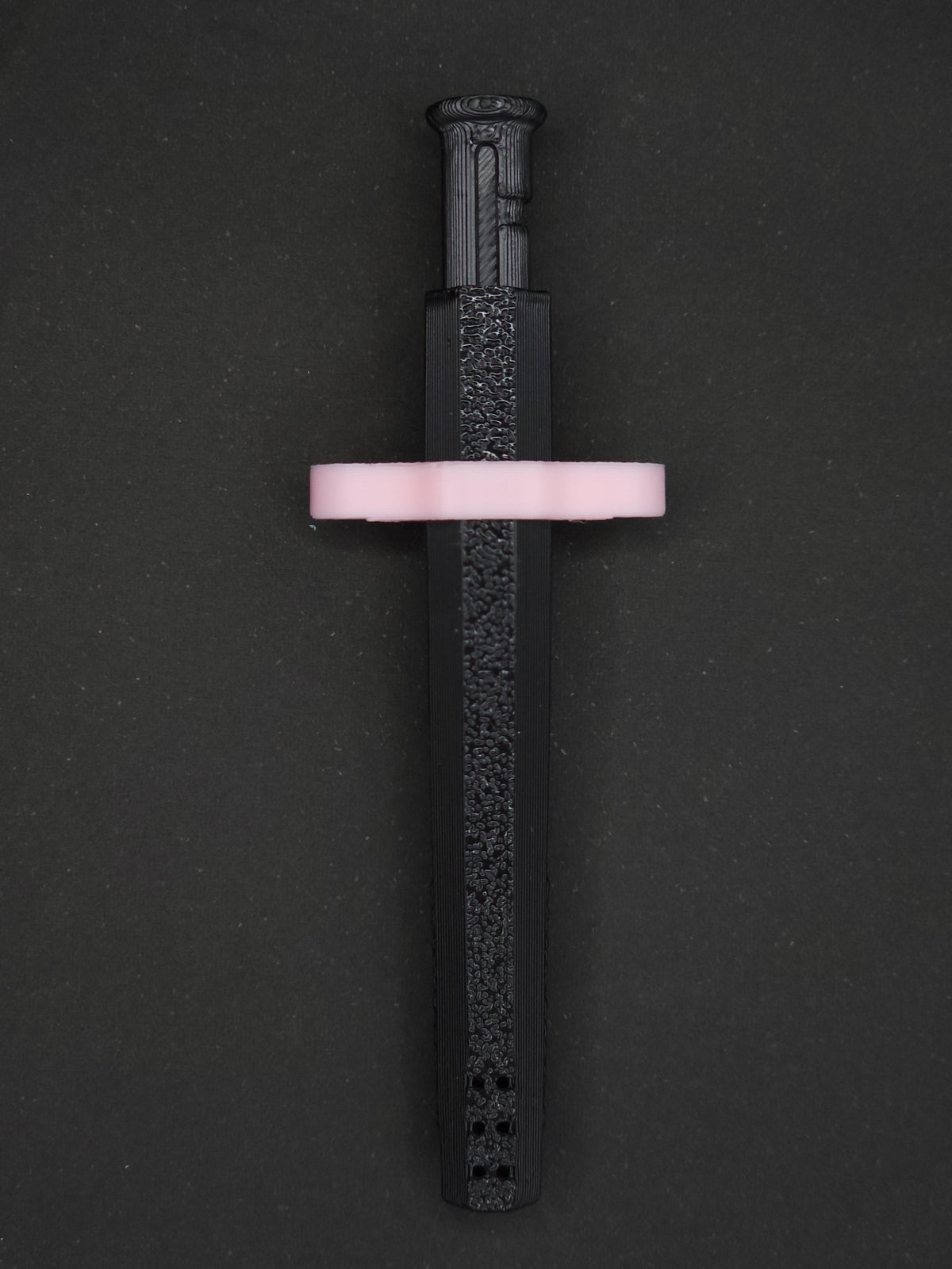 Pink necklace adapter on a Black Sniff & Slide spring-loaded bump straw necklace, dark gray background.