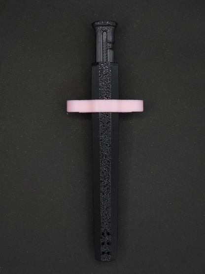 Pink necklace adapter on a Black Sniff & Slide spring-loaded bump straw necklace, dark gray background.