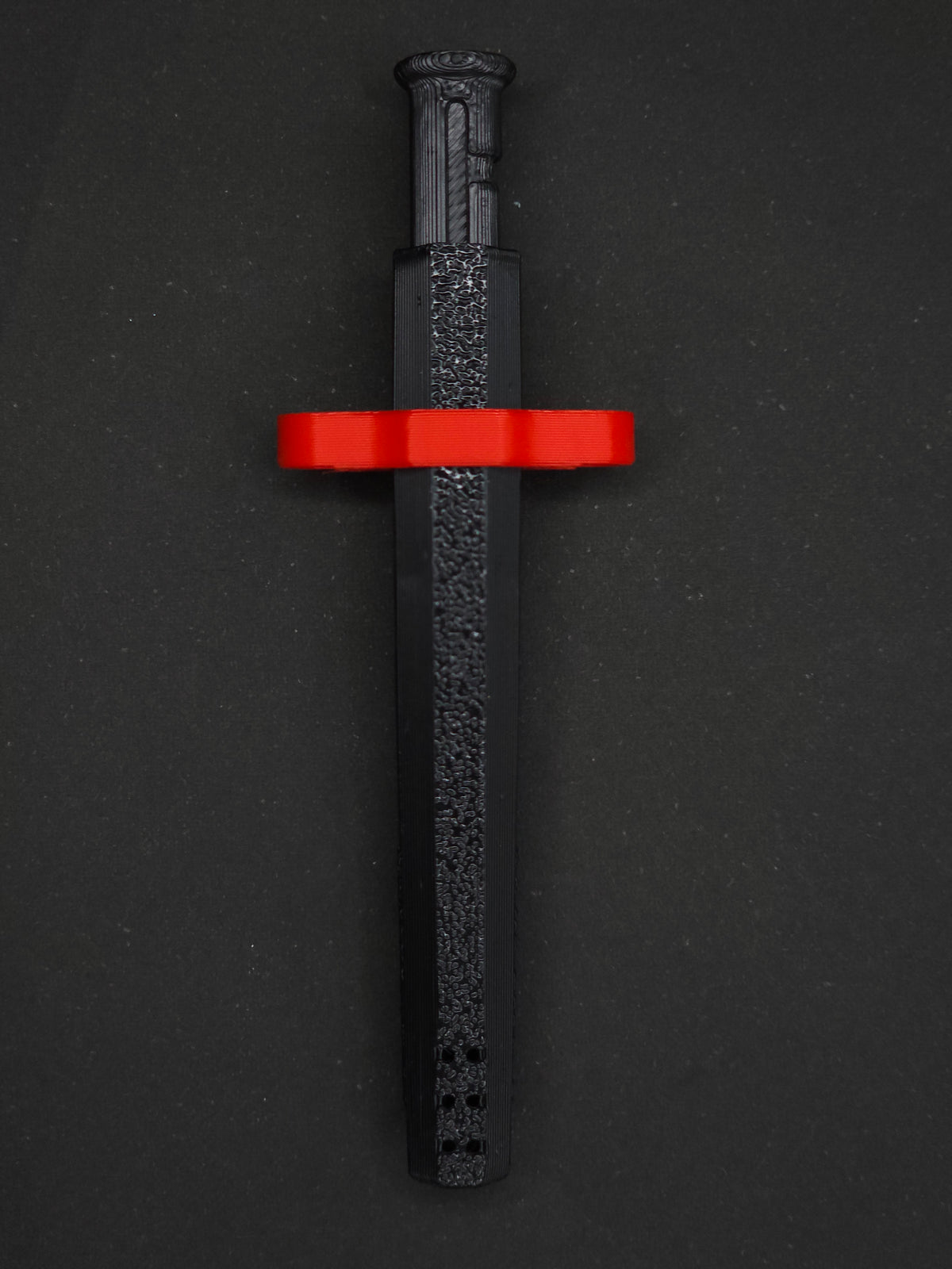 Red necklace adapter on a Black Sniff & Slide spring-loaded bump straw necklace, dark gray background.