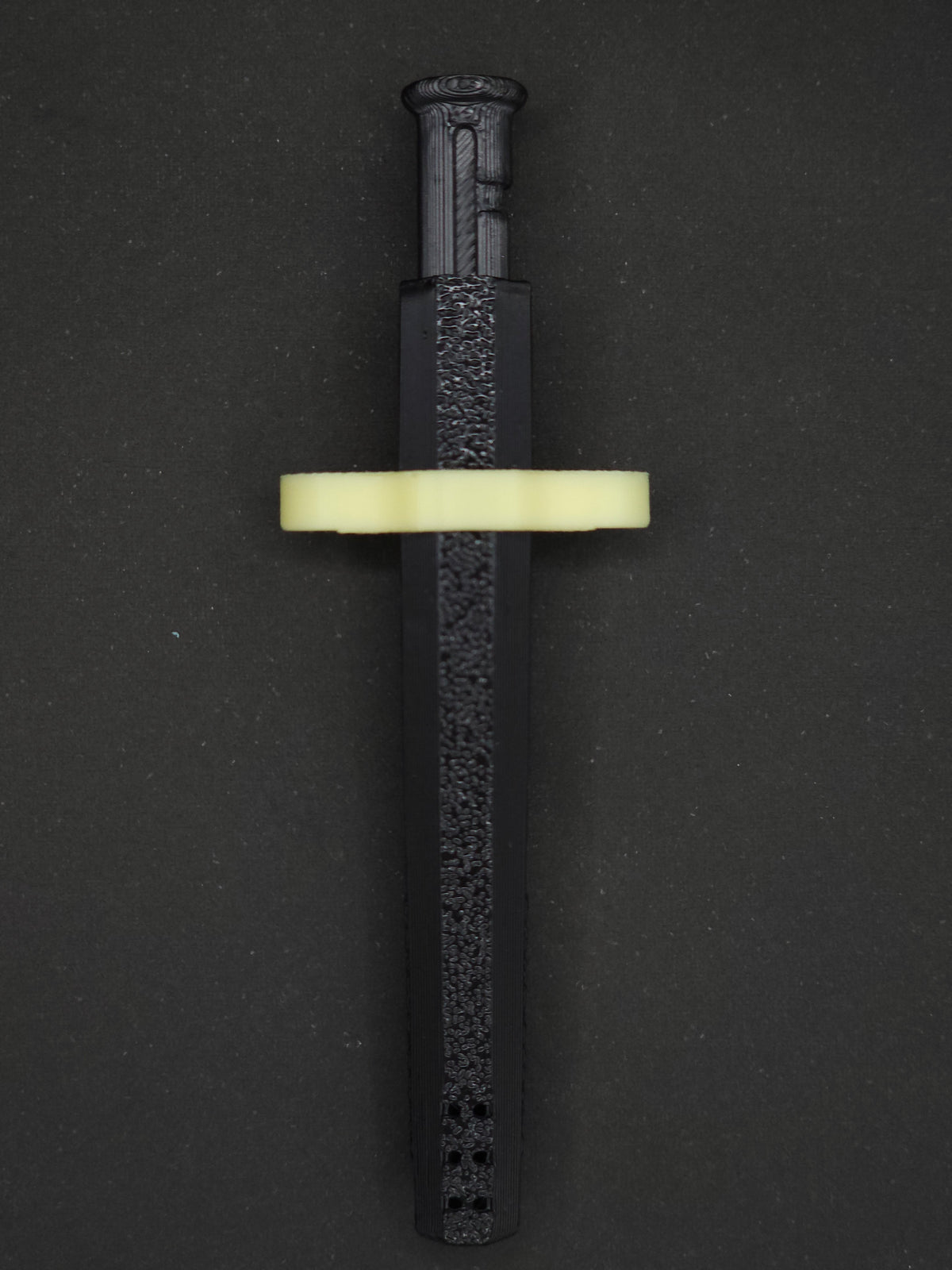 Yellow necklace adapter on a Black Sniff & Slide spring-loaded bump straw necklace, dark gray background.