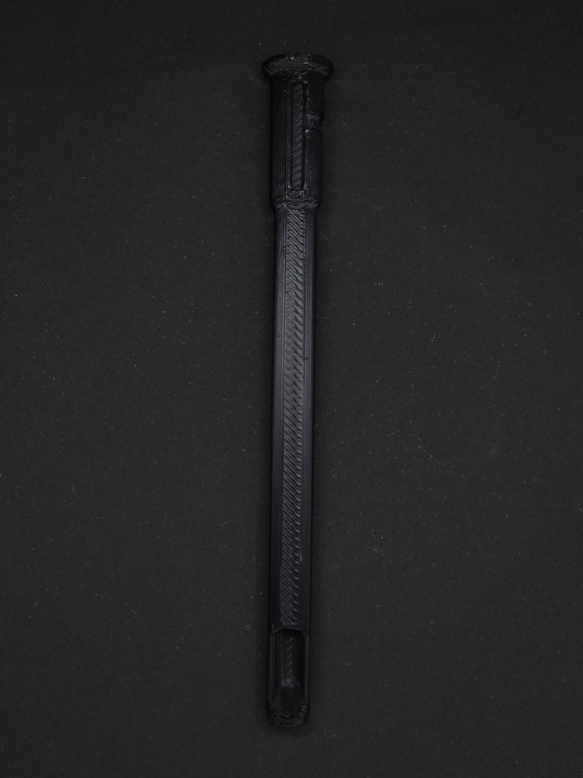 A black textured plastic straw scoop insert accessory, shown vertically on a dark gray background.