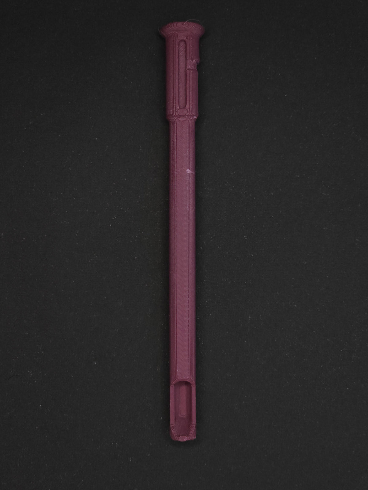 A burgundy textured plastic straw scoop insert accessory, shown vertically on a dark gray background.