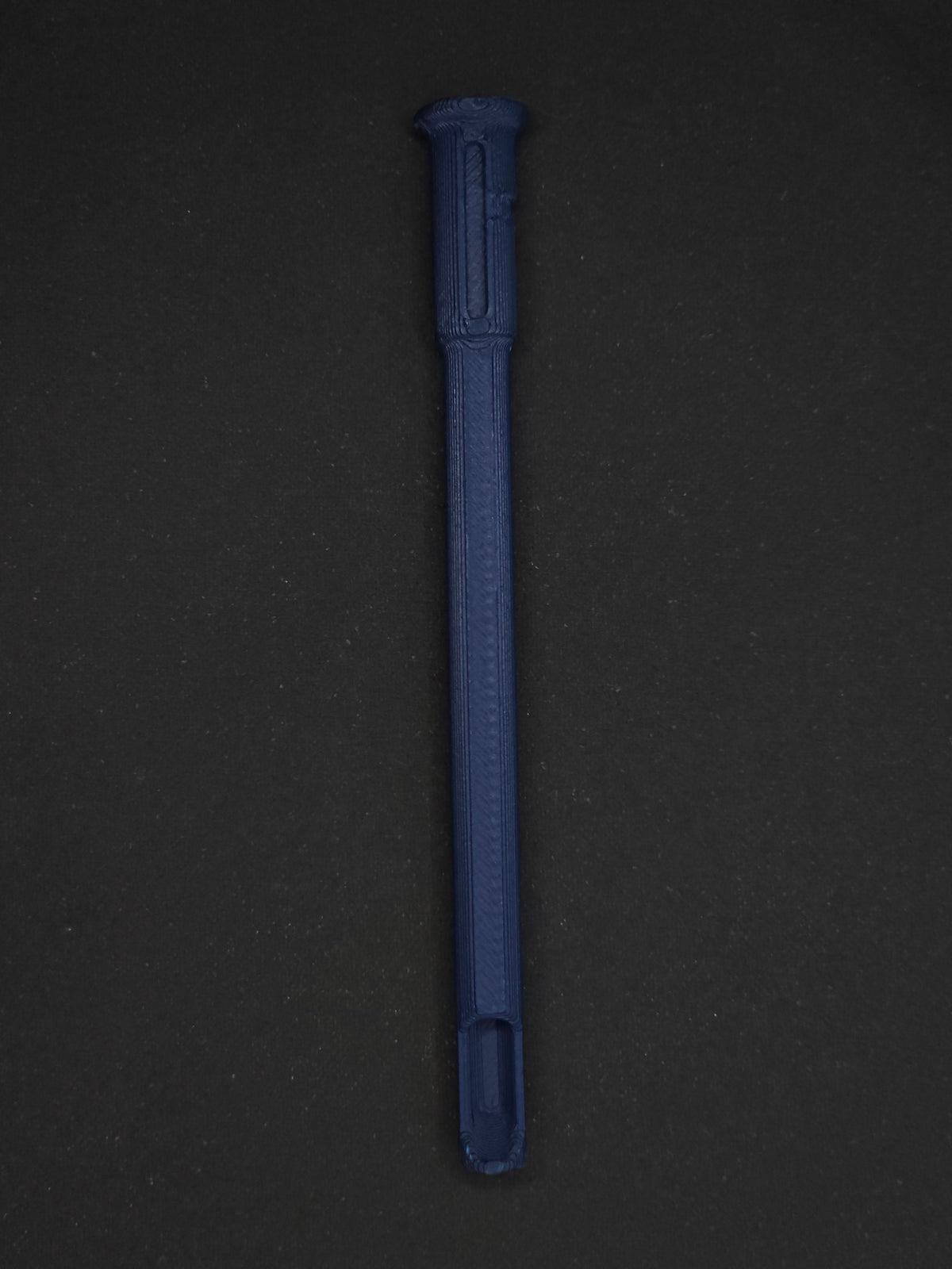 A dark blue textured plastic straw scoop insert accessory, shown vertically on a dark gray background.