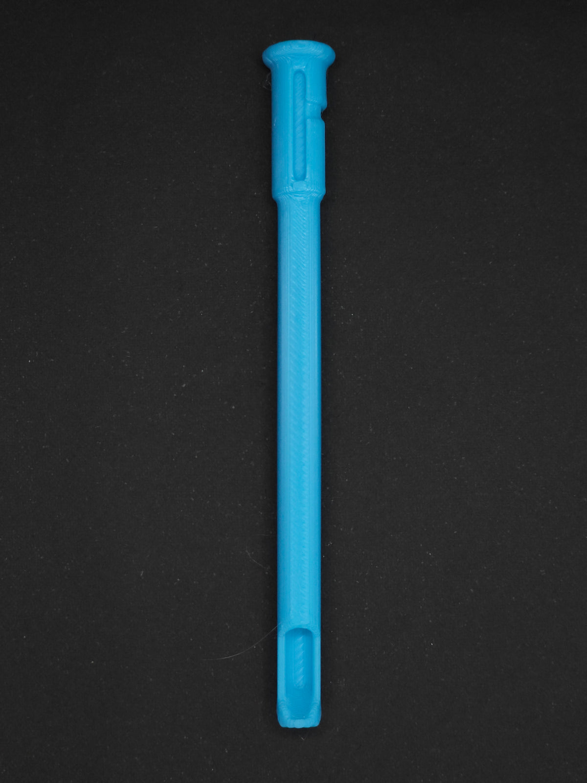 A Sky blue textured plastic straw scoop insert accessory, shown vertically on a dark gray background.