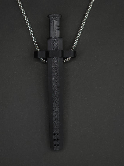 A black spring-loaded bump straw pendant on a silver box chain, displayed against a dark textured background