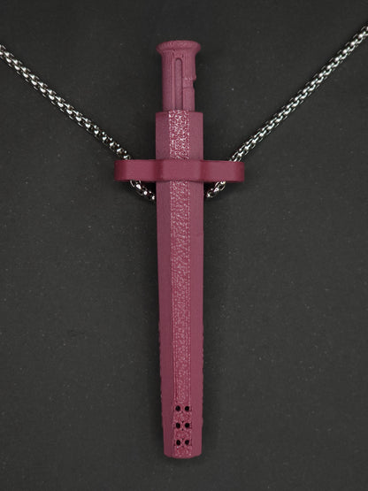A burgundy spring-loaded bump straw pendant on a silver box chain, displayed against a dark textured background