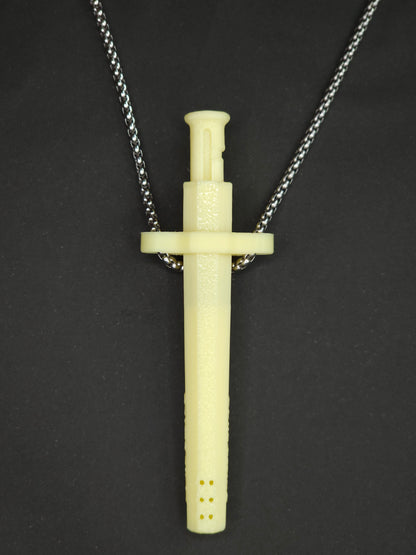 A yellow spring-loaded bump straw pendant on a silver box chain, displayed against a dark textured background