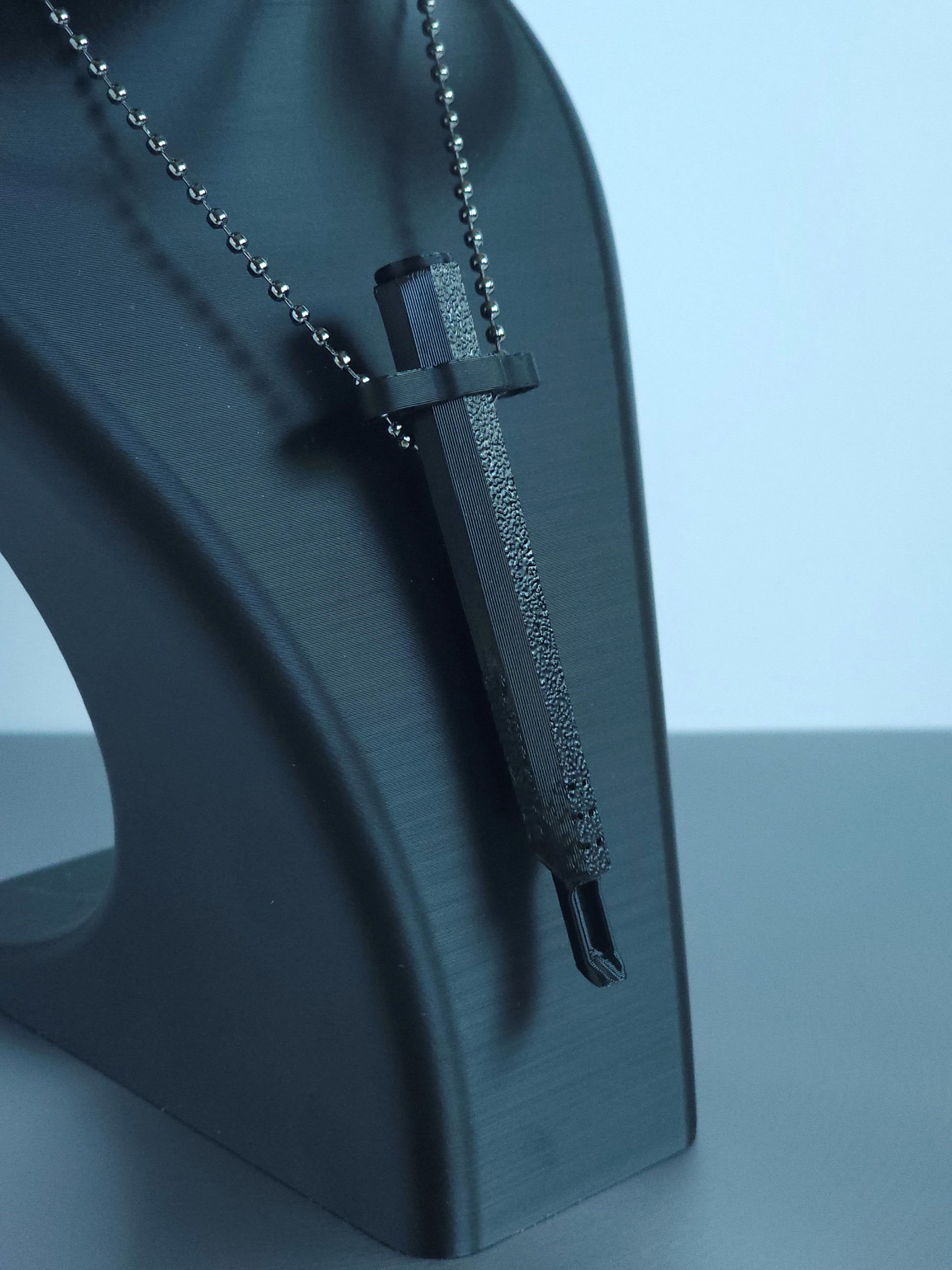 Sniff & Slide spring-loaded bump straw in Onyx Black with silver ball chain, displayed on black mannequin bust, over a white and grey background. The insert is extended, showing the straw scoop functionality.