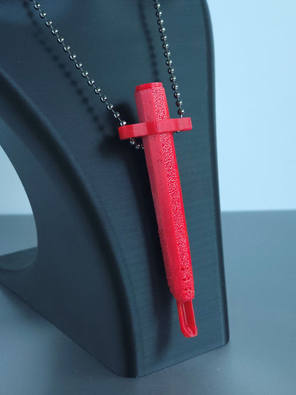 Sniff & Slide spring-loaded bump straw in vibrant Red with silver ball chain, displayed on black mannequin bust, over a white and grey background. The straw/scoop insert is extended.